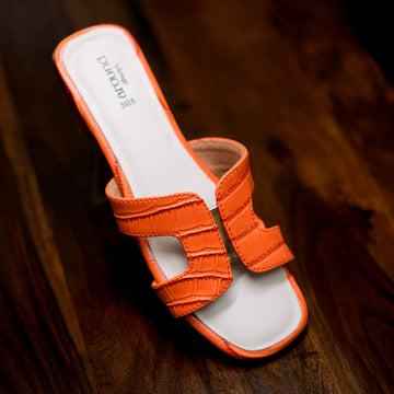 Orange heeled slider with an embossed crocodile pattern and contemporary design.