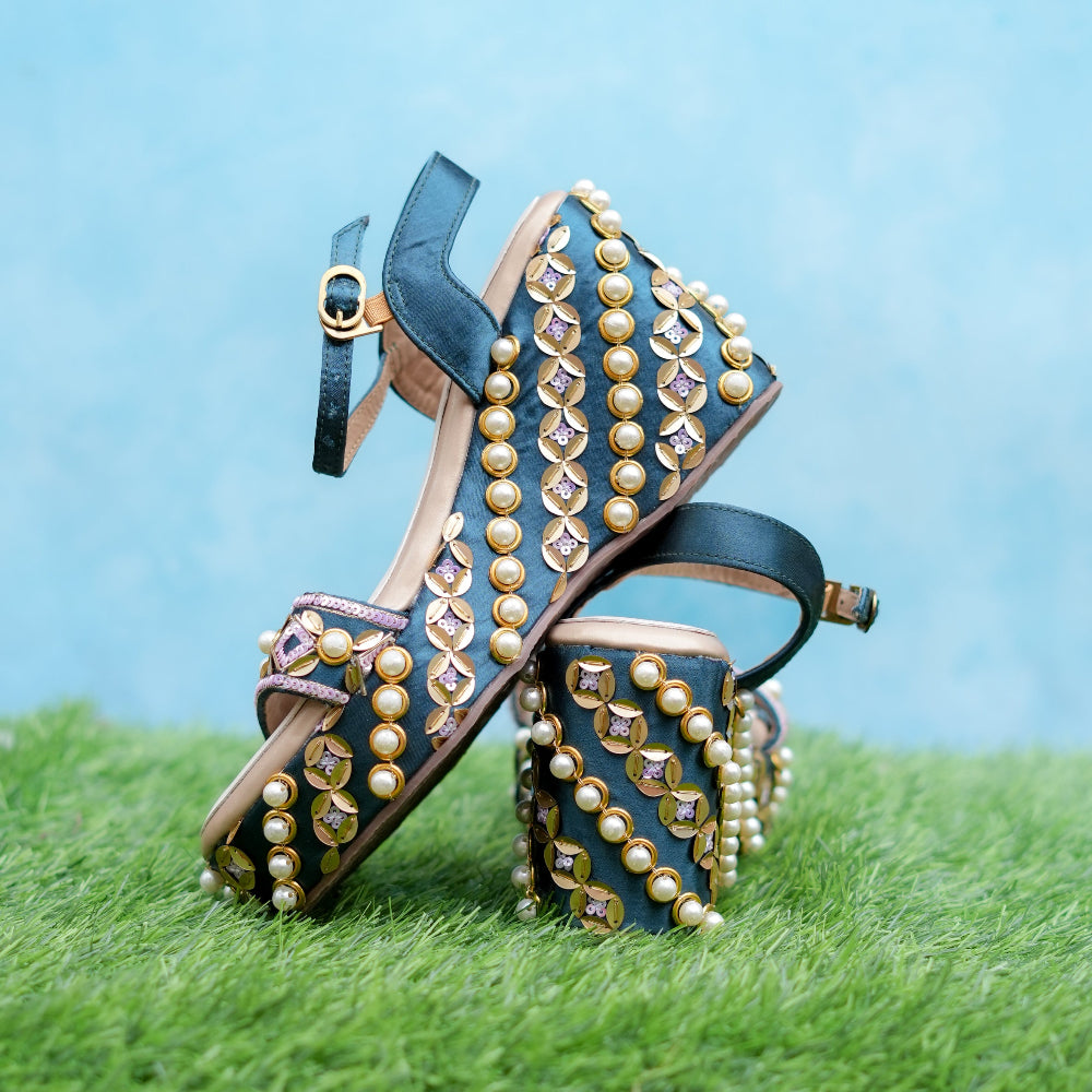 Navy wedge sandals with pearl embellishments and intricate gold detailing.