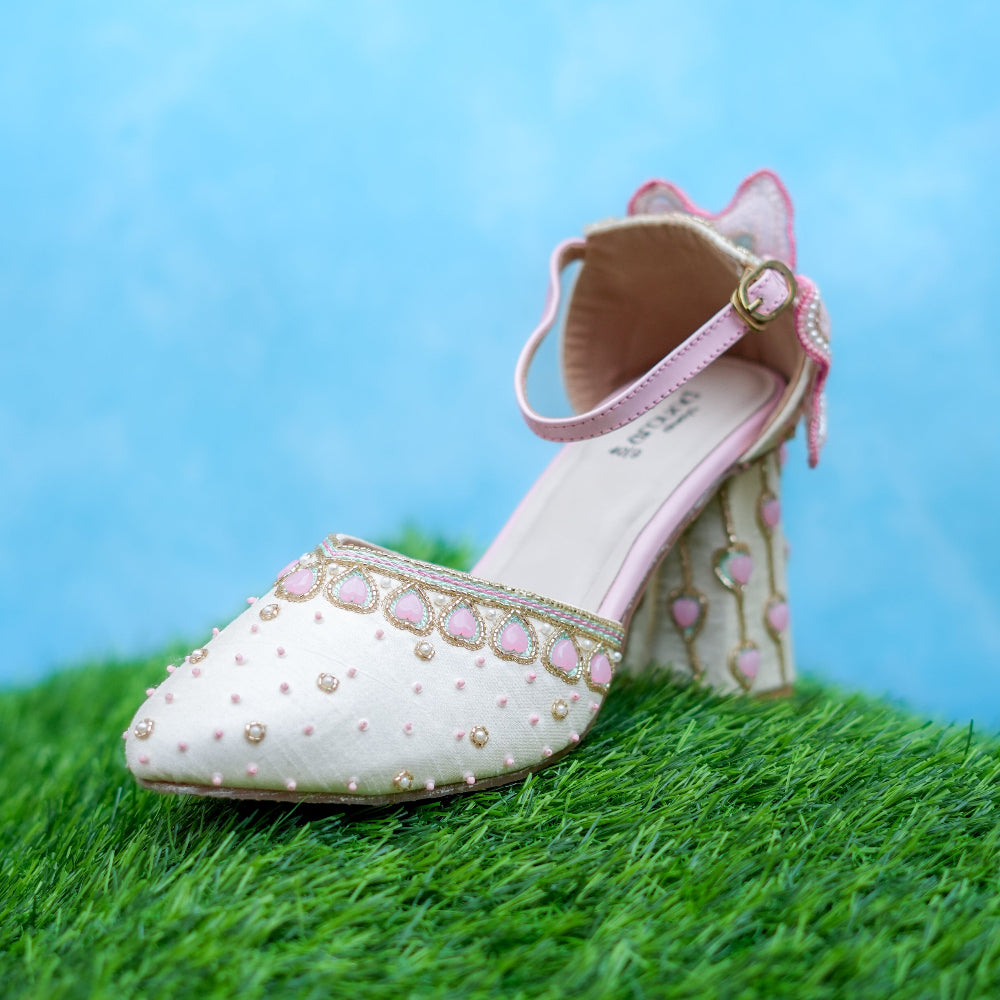 Ivory block heels with pink heart embellishments and delicate pearl detailing.
