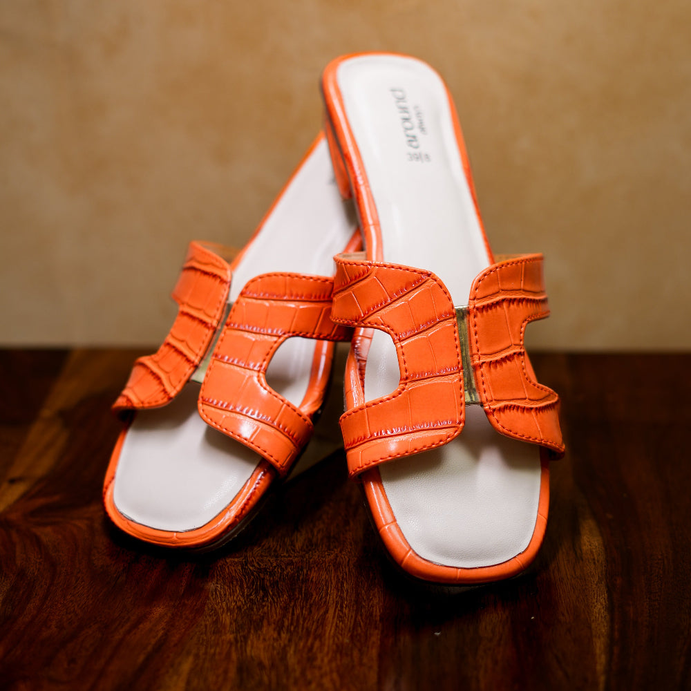 Textured orange slider with crocodile embossing and an elevated heel.