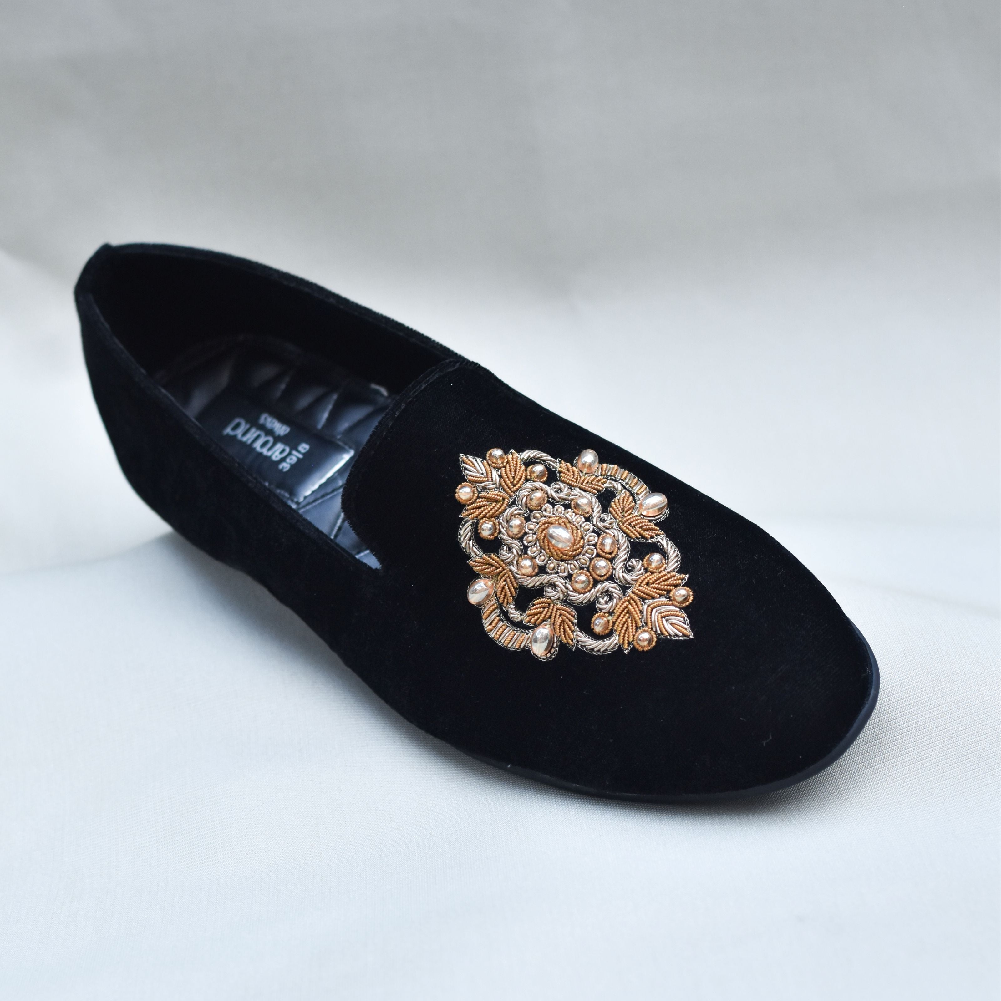 Black Indo-Western loafers for men with golden zardozi embroidery and stonework for sangeet or wedding events.