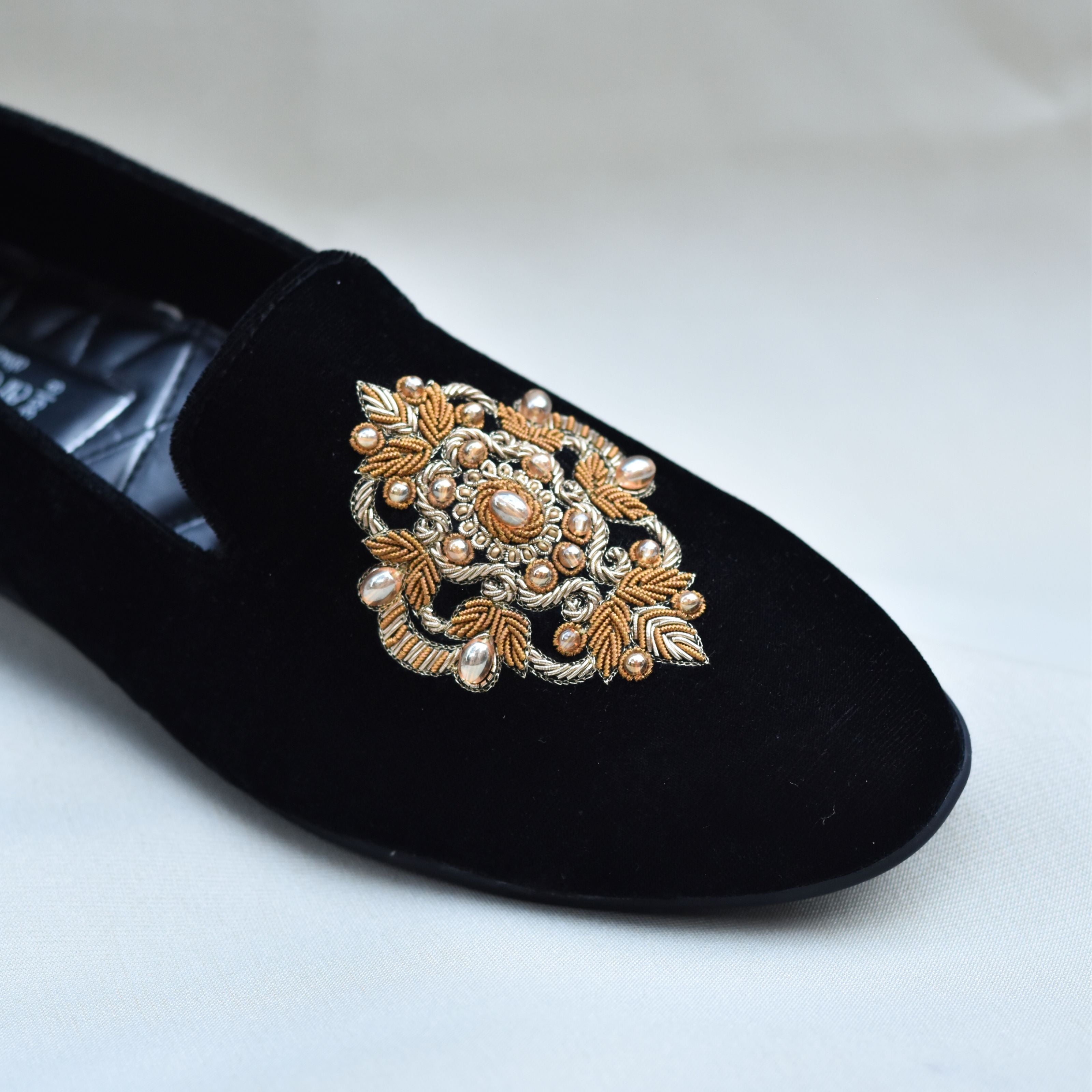 Stylish black groom loafers with intricate zardozi embroidery and stone accents.