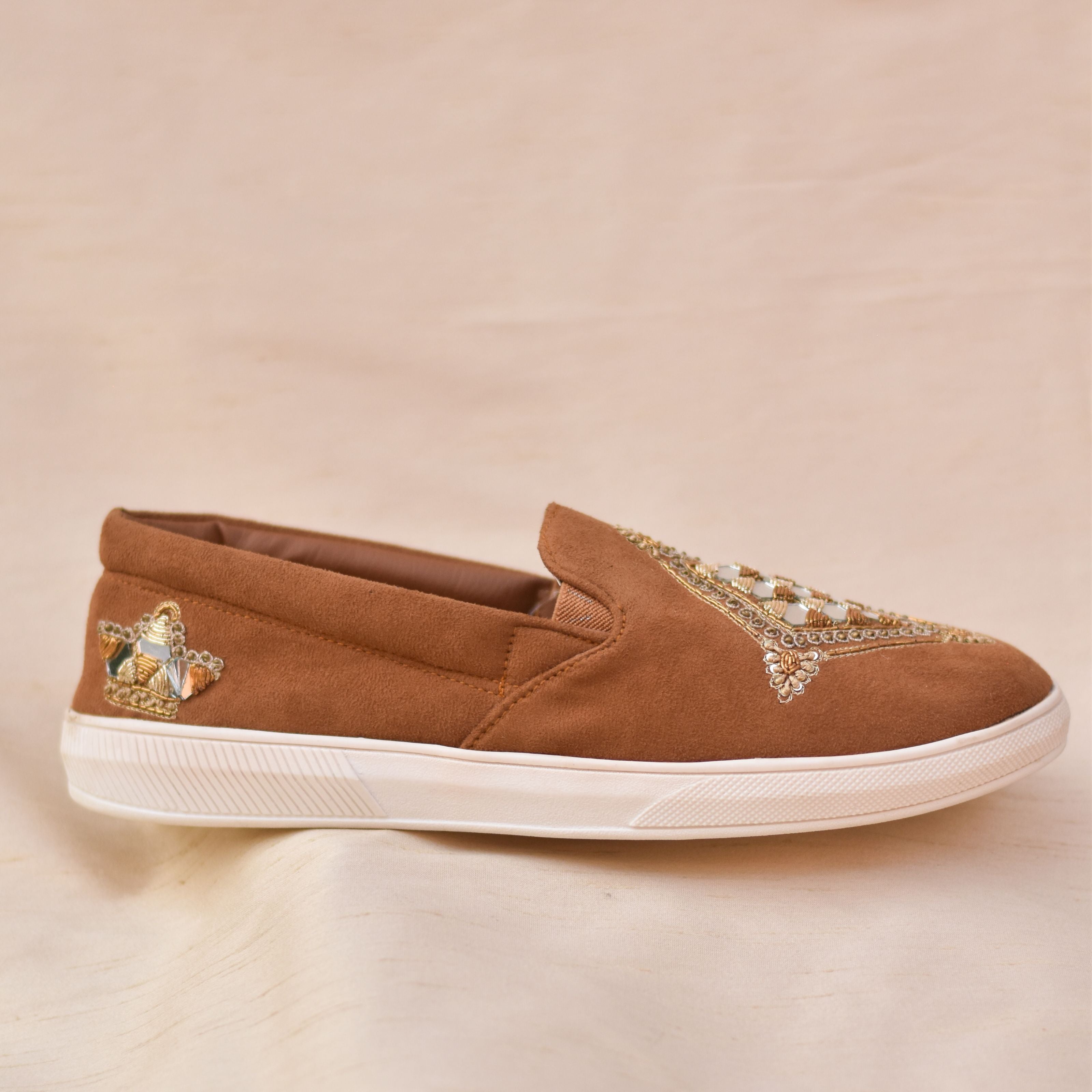 Modern ethnic handcrafted tan sneakers for men with zari embroidery and mirror details for casual wedding looks.