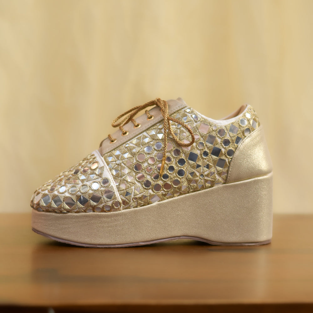 Festive wedge sneakers in champagne tone with intricate mirror work and cushioned platform