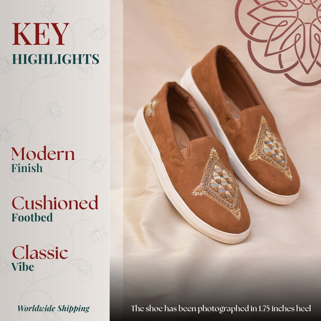 Casual tan slip ons featuring handcrafted threadwork detail