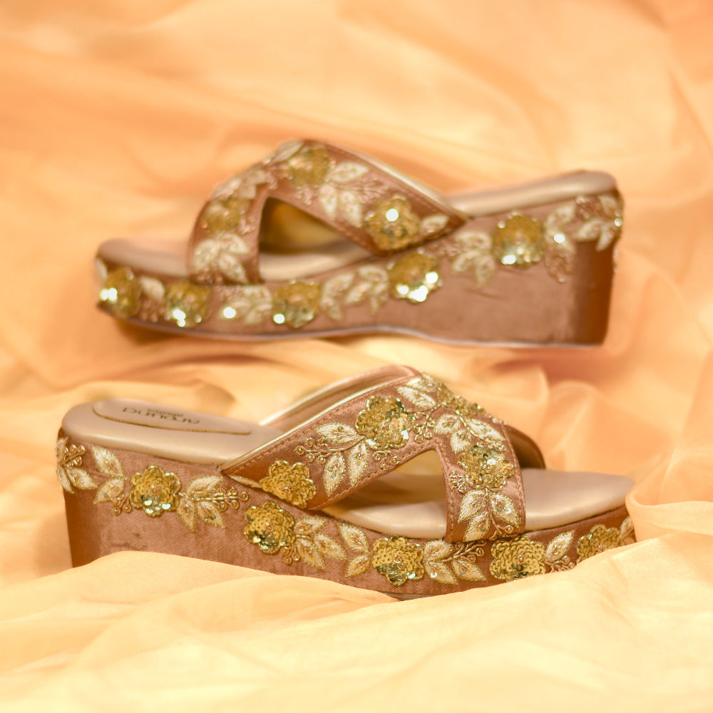 Golden occasion wedges with intricate floral detailing and cushioned footbed
