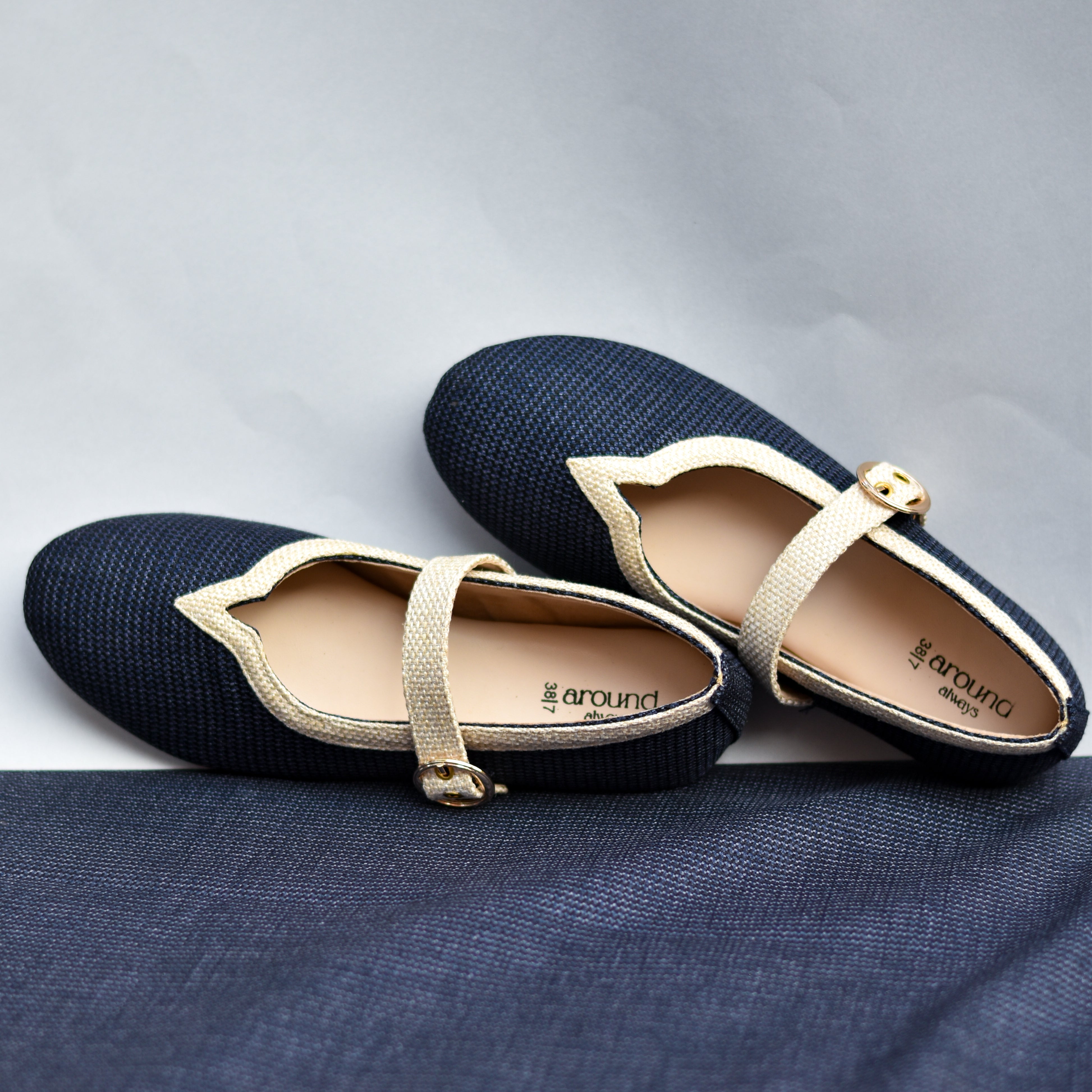 Elegant navy Mary Janes featuring structured strap and cream fabric accent