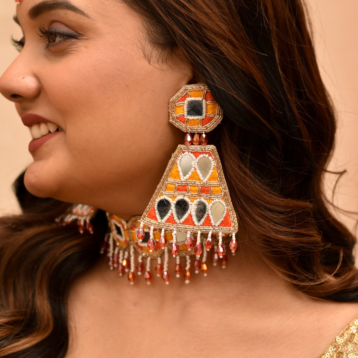 Woman's trendy long earrings for haldi mehendi celebrations