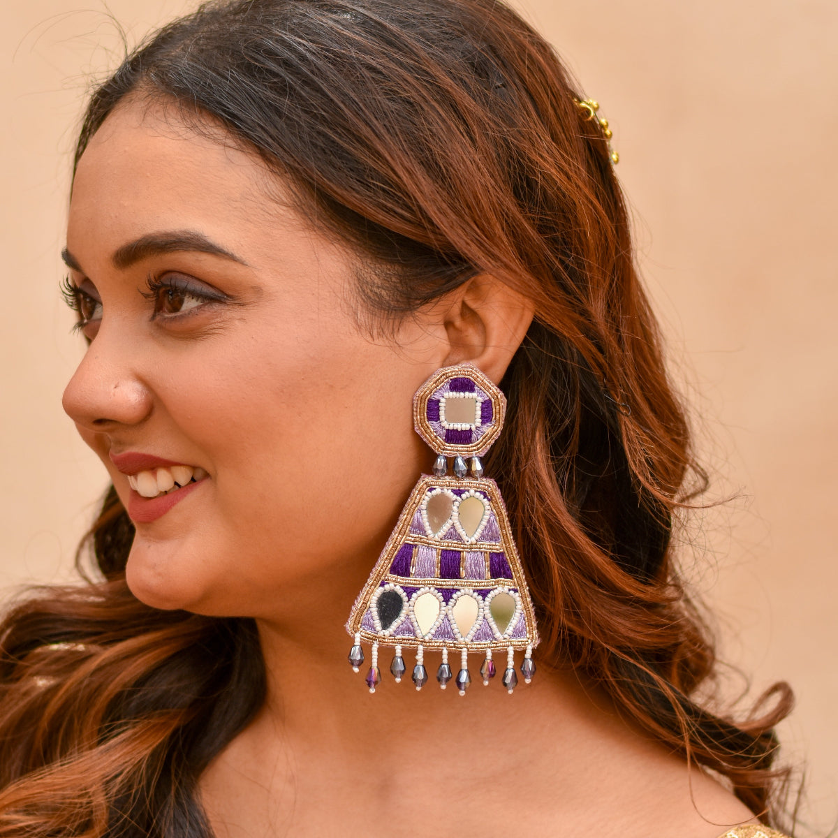 Woman wearing a decorative earring for a haldi look