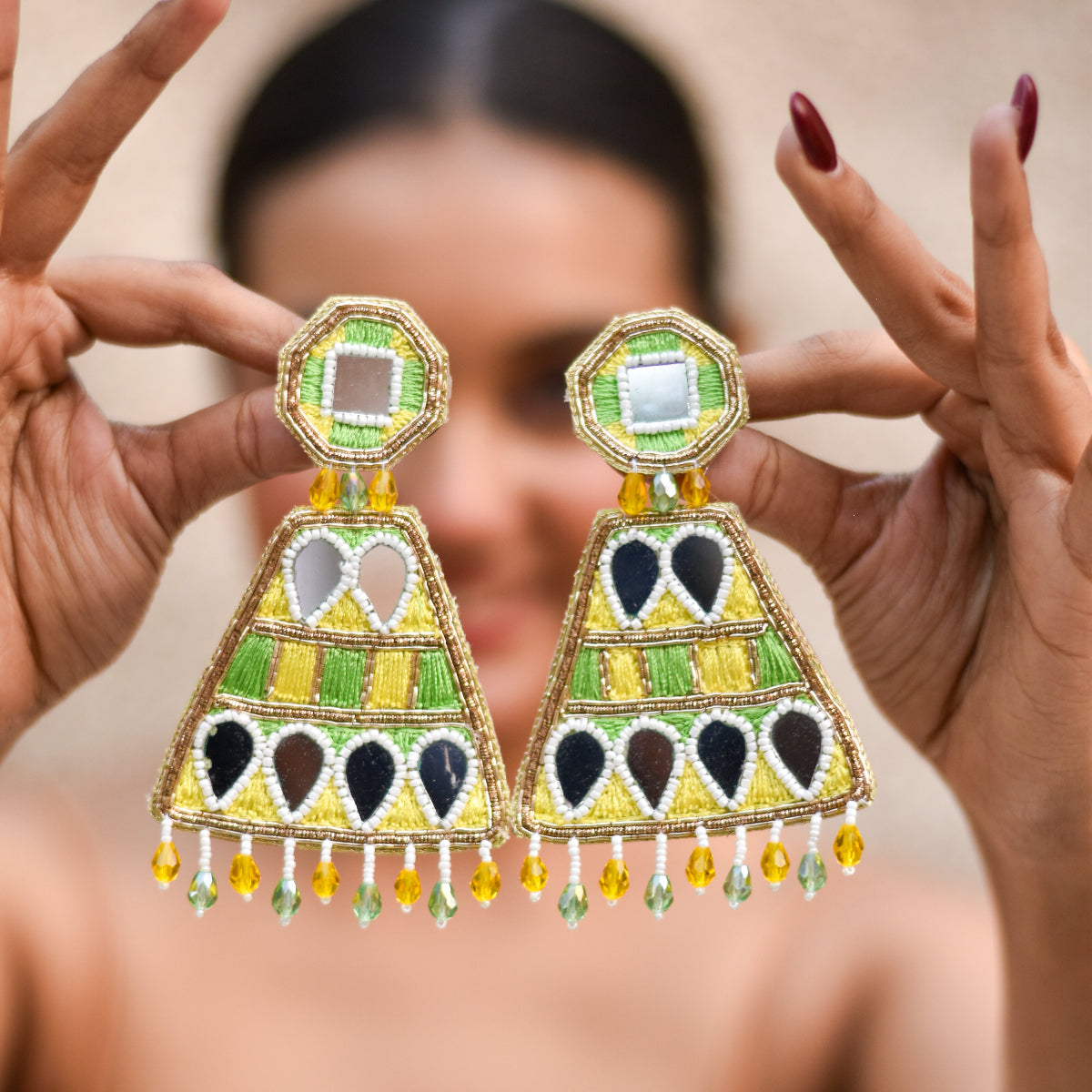 Colorful beaded earrings with yellow and green thread, touch of zardozi and mirrors for some bling during haldi.