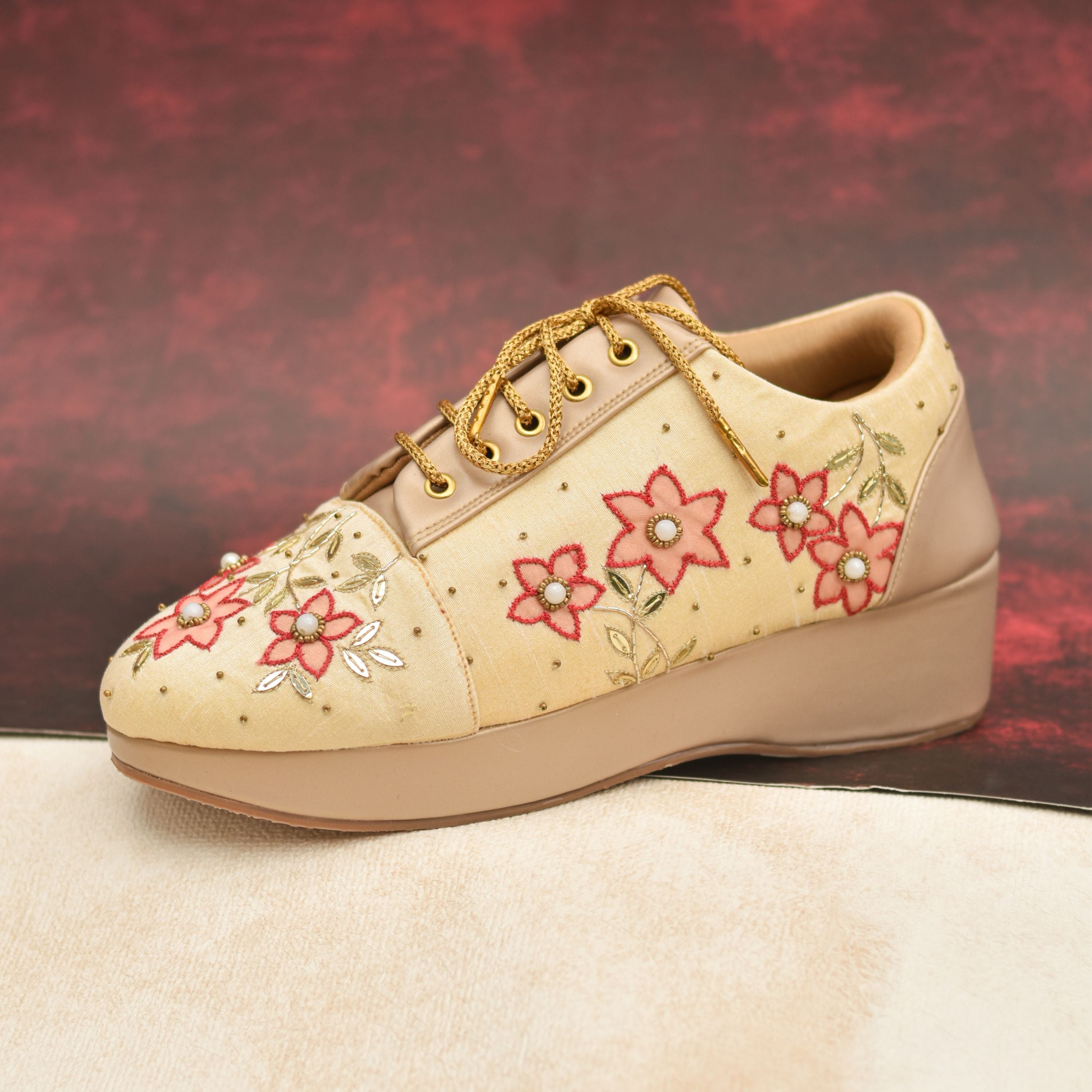 Floral embroidered wedding sneakers with pearl accents.