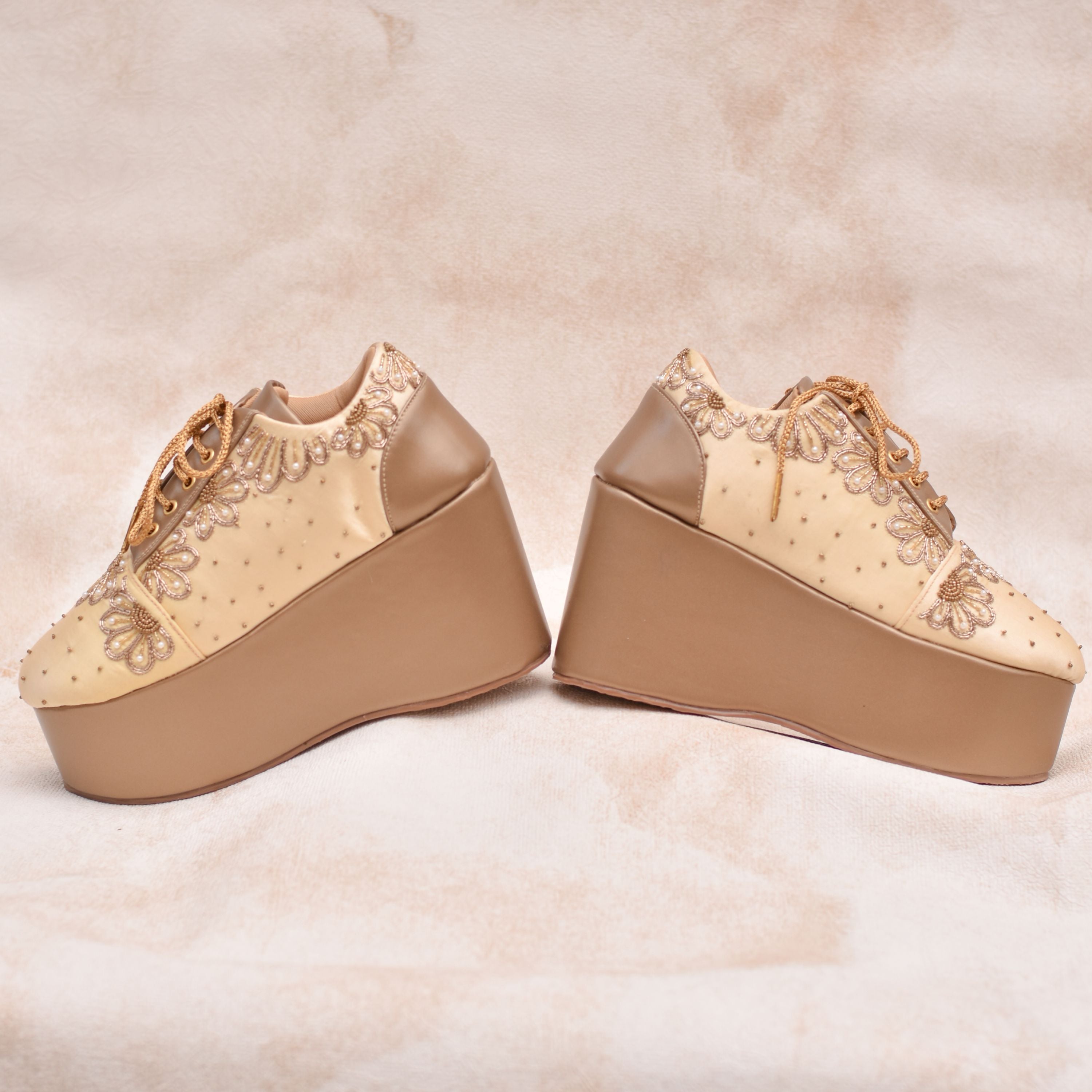 Handmade champagne sneaker with oversized golden flowers and chunky wedge heel.