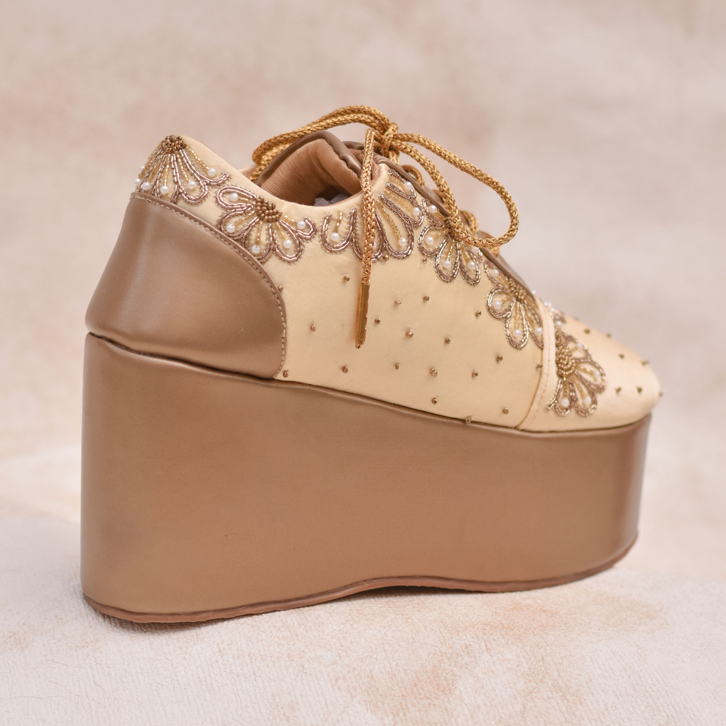 Statement bridal footwear with bead-dotted champagne base and high platform sole.
