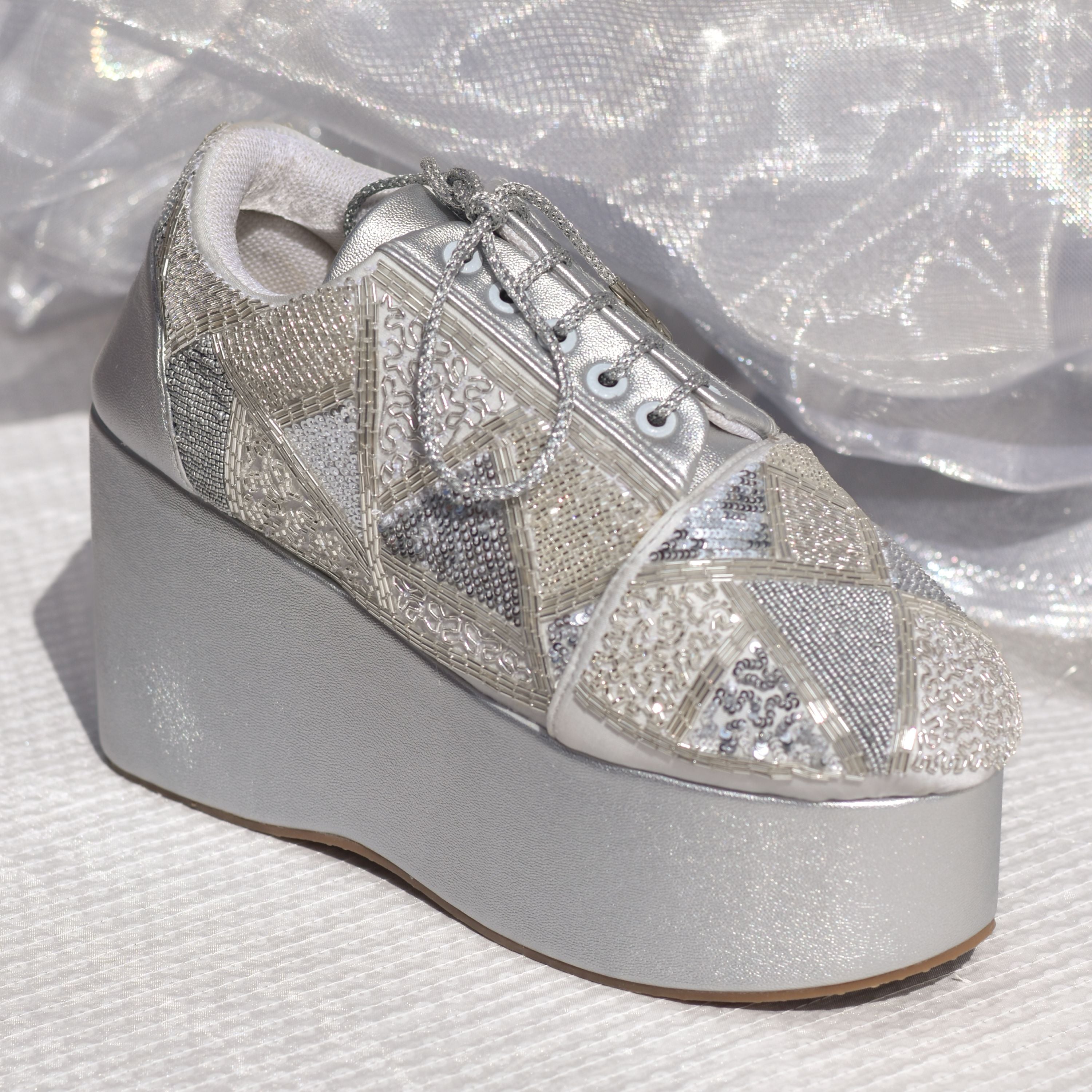 Metallic high platform bridal sneakers in silver with shimmer detailing.