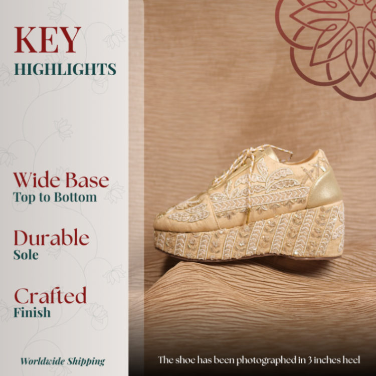 Gold embroidered sneaker wedges with intricate detailing and a wide comfortable platform