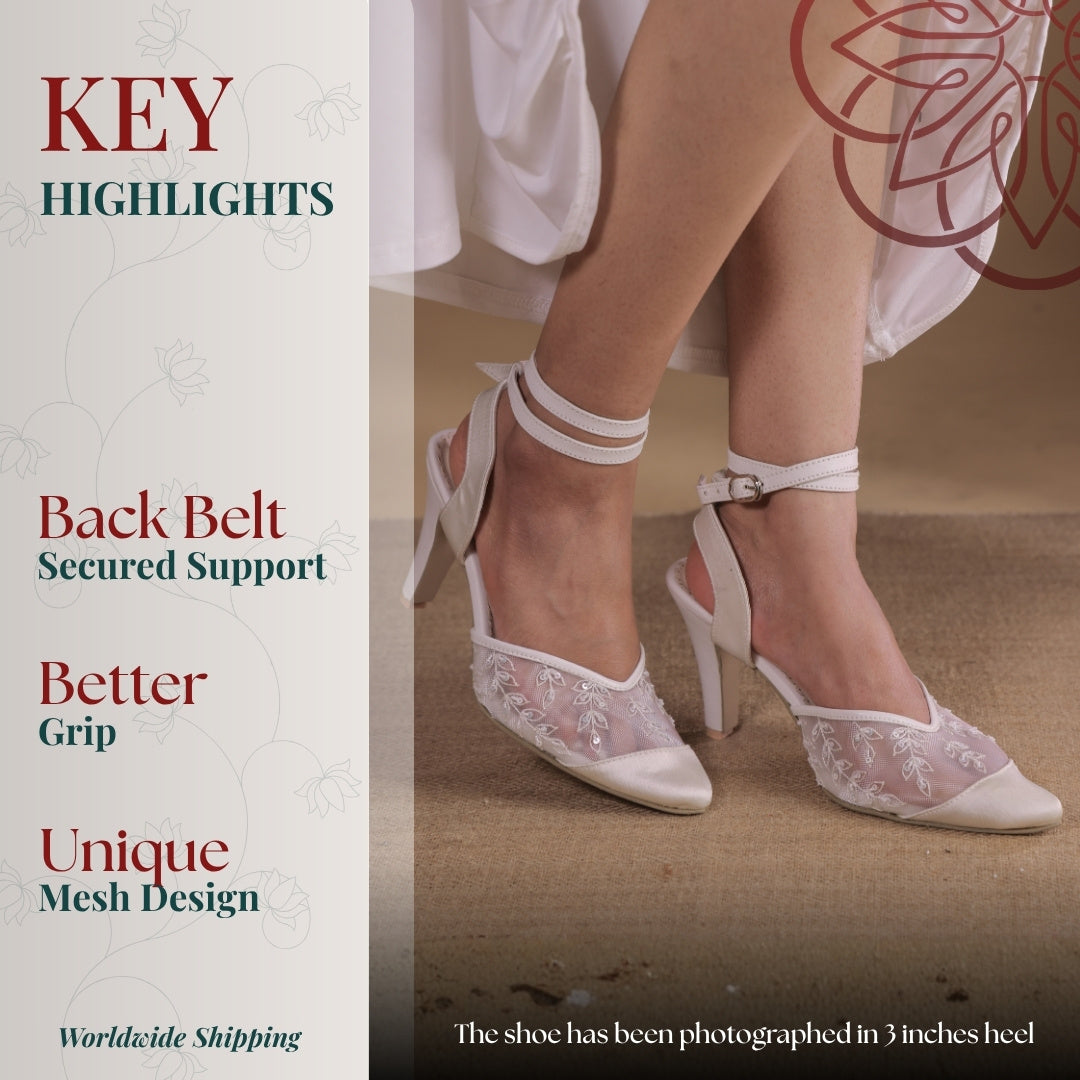 White pointed toe heels with sheer embroidered mesh, back strap support and stable high heel grip