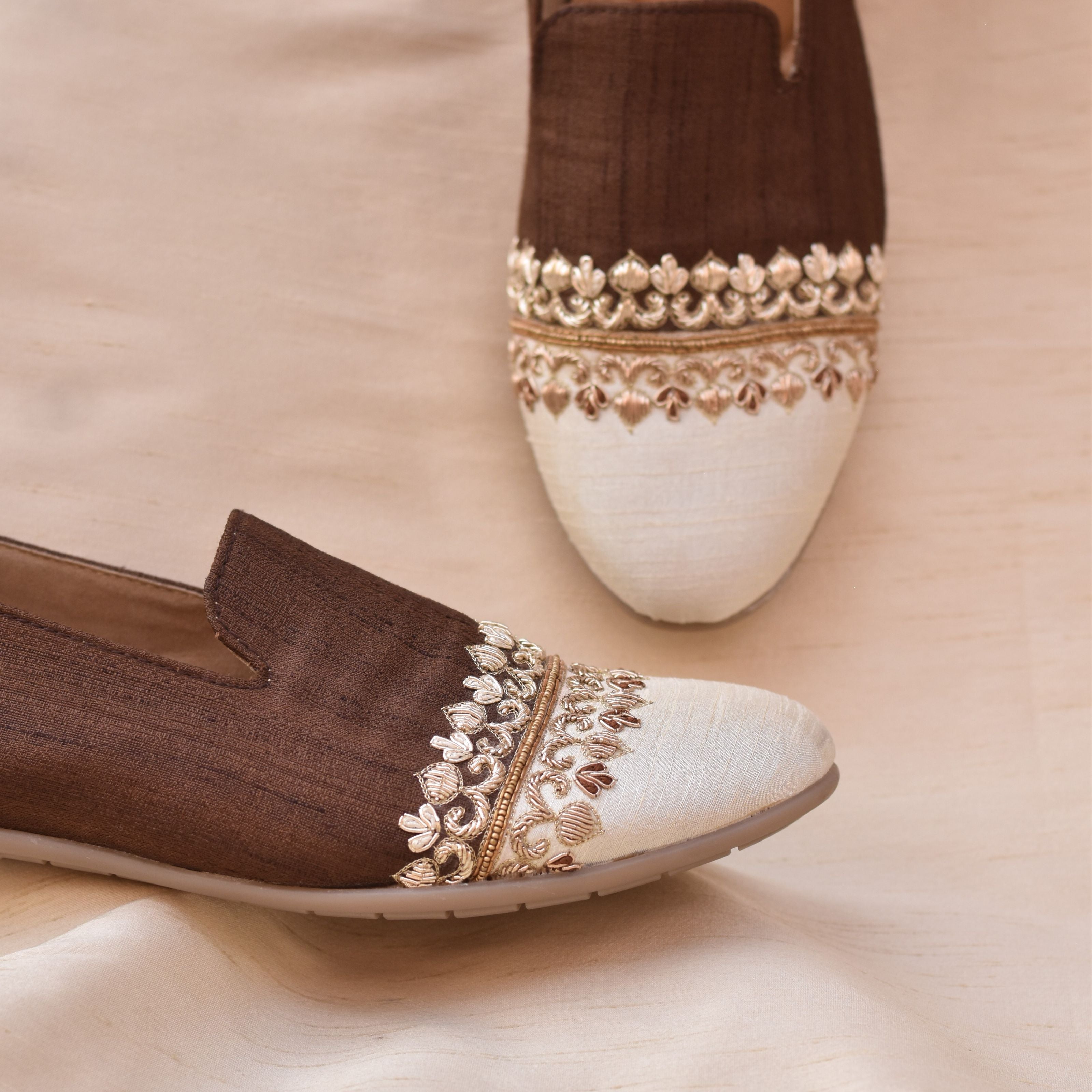 Elegant brown slip-on loafers for men with contrasting white toe and gold detailing