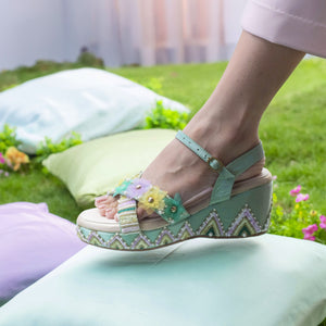 Turquoise blue wedge sandals with floral detailing and ankle strap