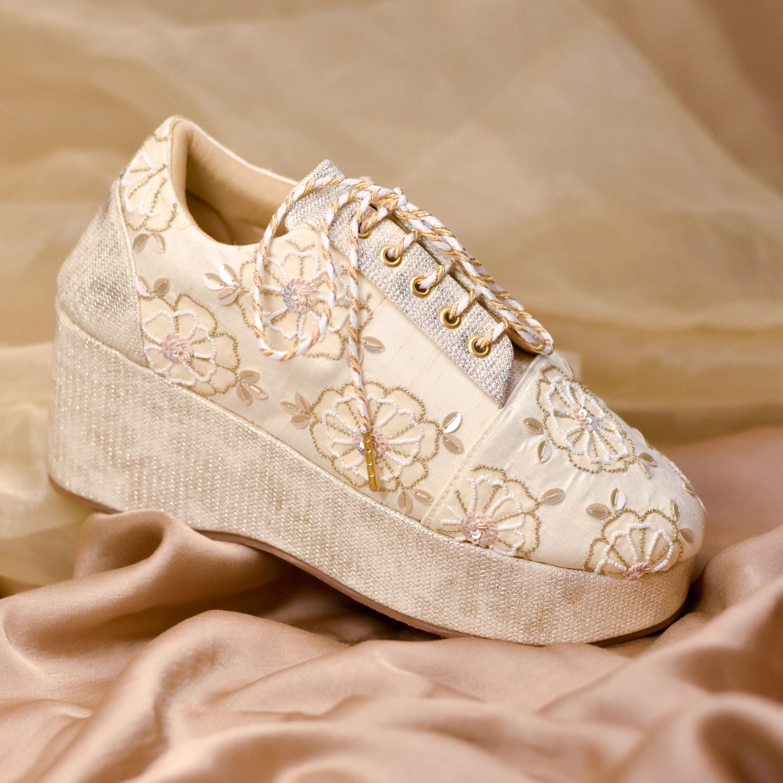 Textured platform sneakers in champagne tones with floral patterns and sequin shine