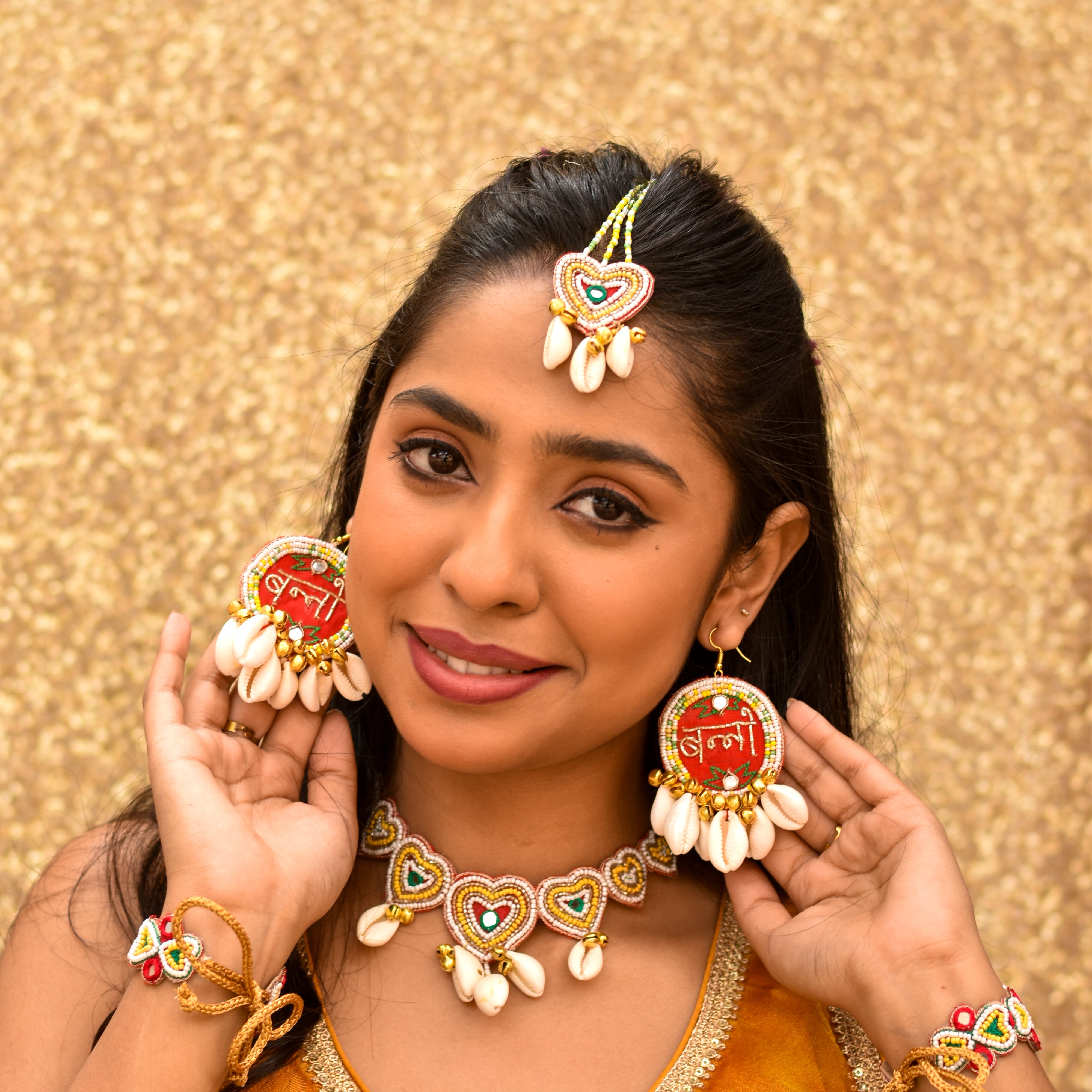 Haldi quirky earrings with a red base and golden zardozi embroidery 