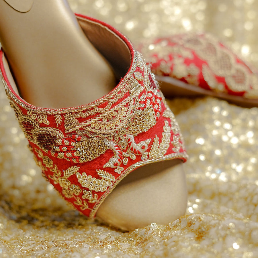 Occasion sandals in vibrant red with beadwork, thread embroidery, and a comfortable low heel.