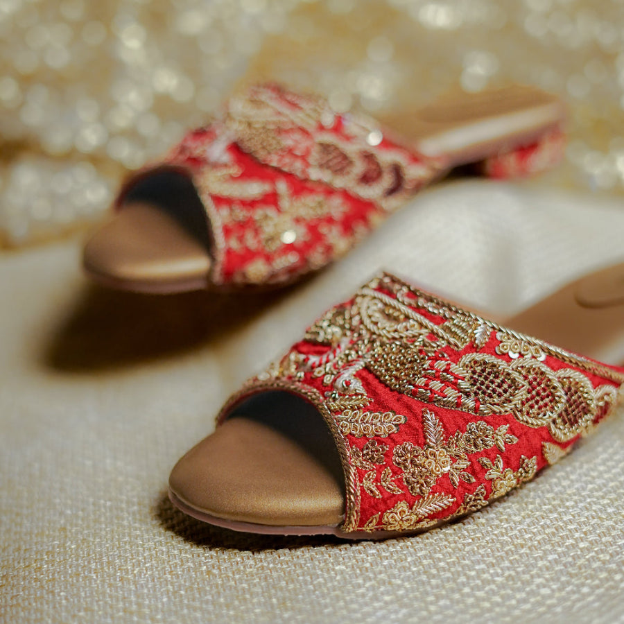 Red ethnic sandals crafted with ornate embroidery, a cushioned footbed, and a low block heel
