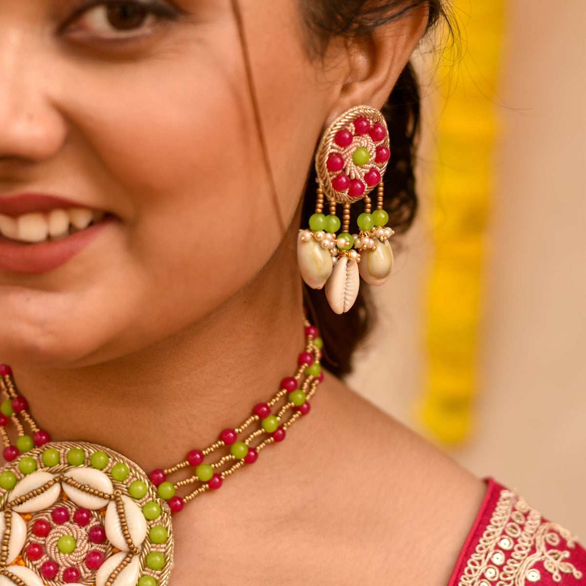 Indian bride wearing beaded rani and green earrings for her haldi look 