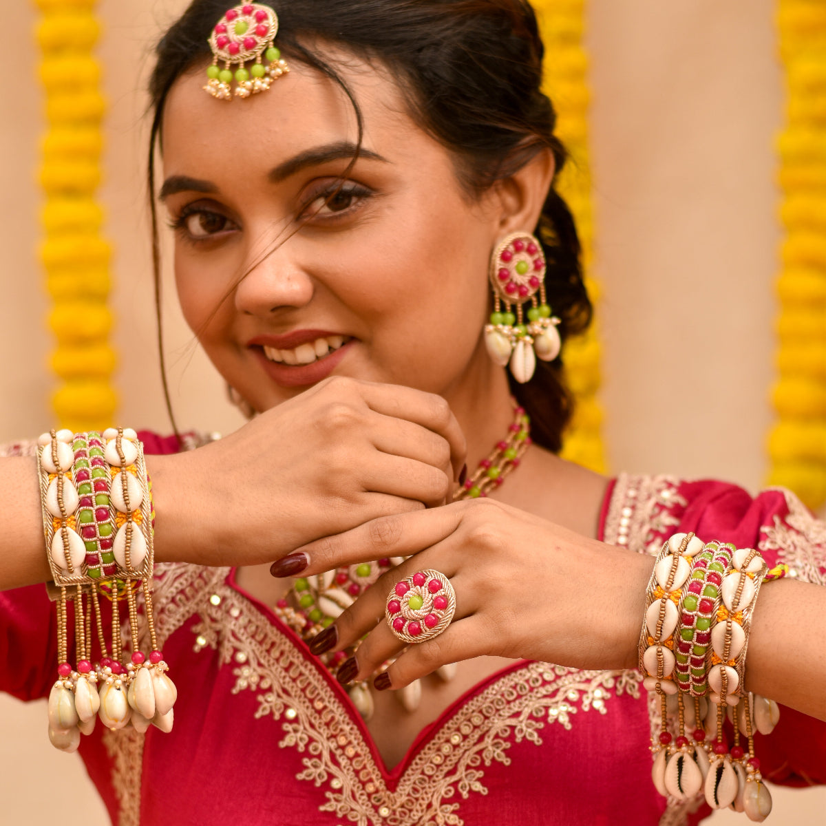 An Indian bride posing candidly in her handmade haldi jewellery set made of beads and zardozi 
