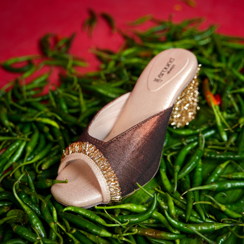 Brown wedge mule with textured gold detailing around the toe
