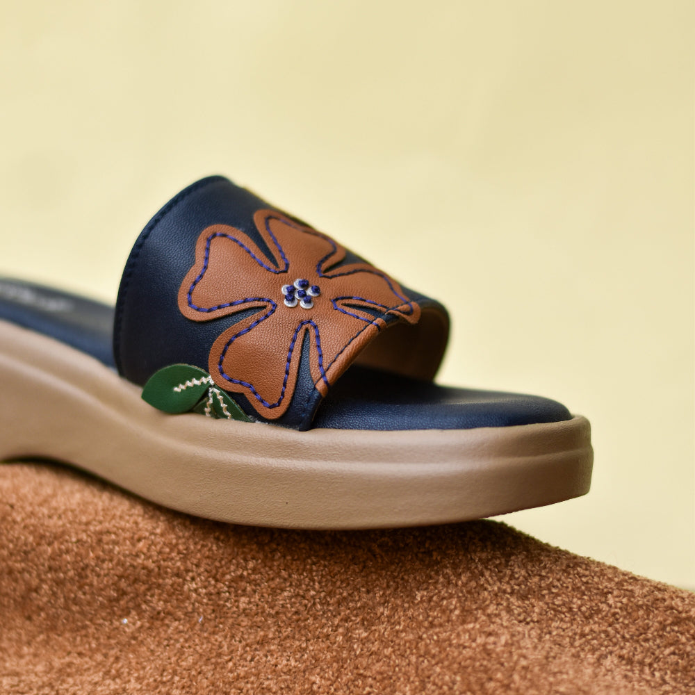 Open-toe navy sandal featuring playful flower appliqués