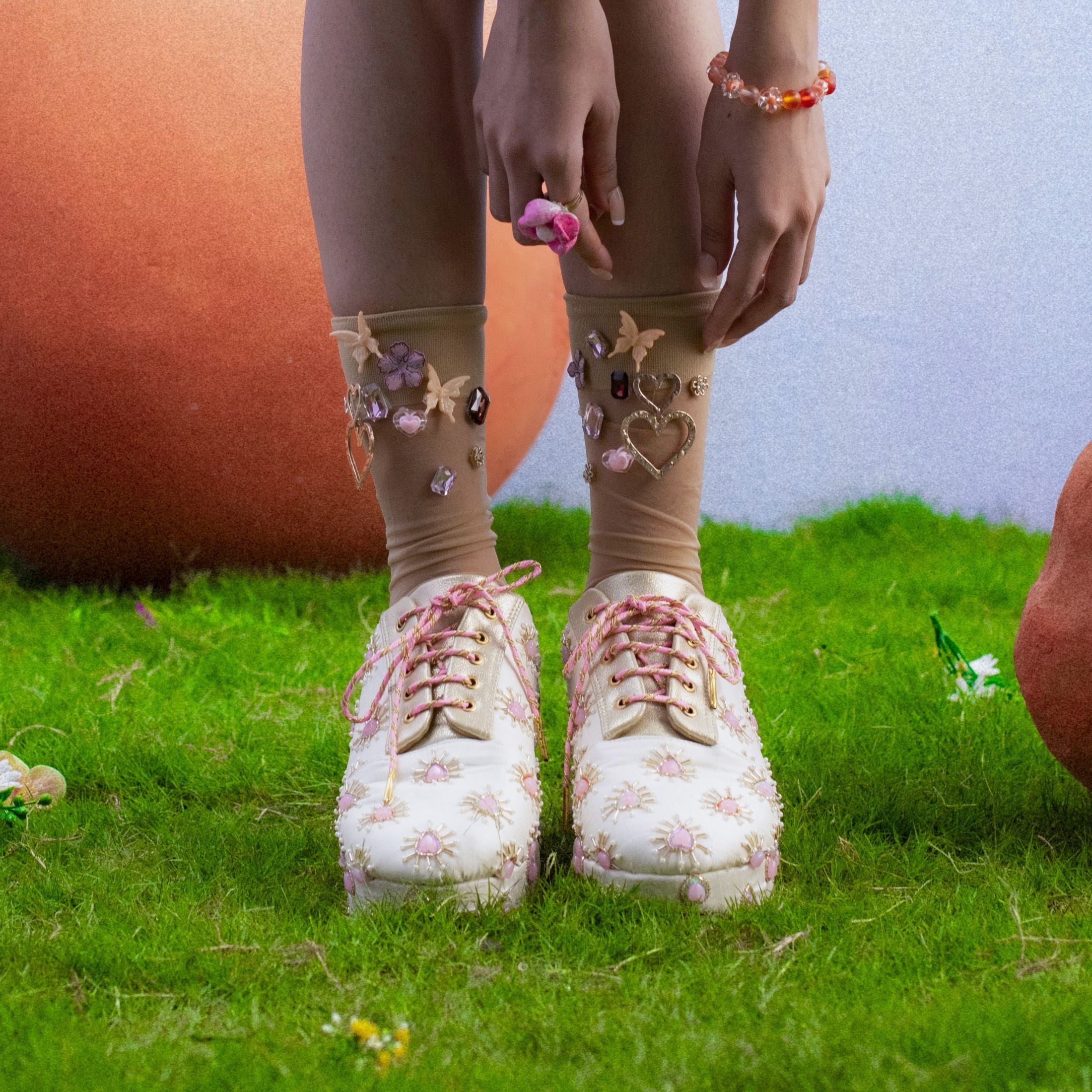 Designer ethnic sneakers with pink detailing and lace-up style