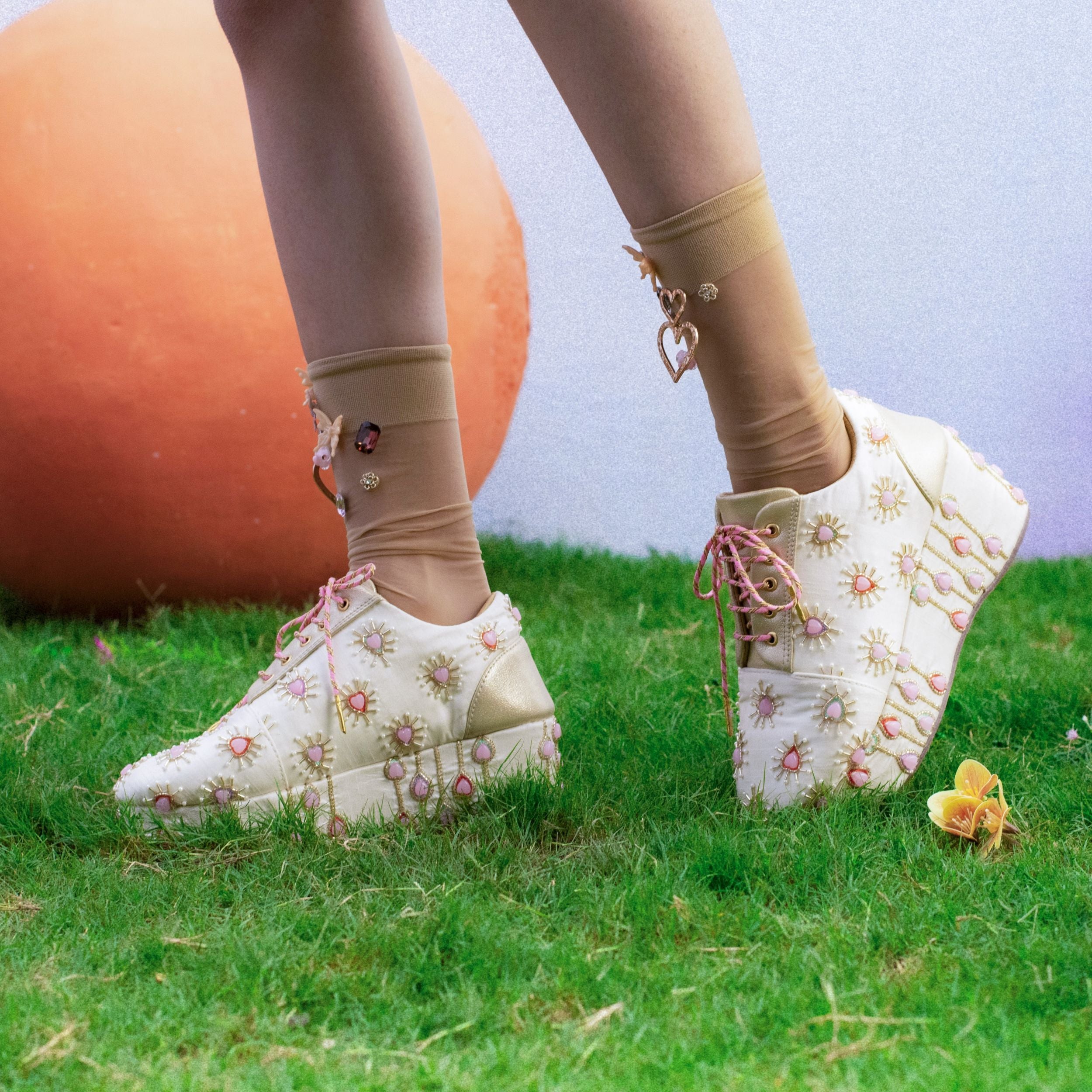 Ivory wedge sneakers with pink embellished heart motif detailing