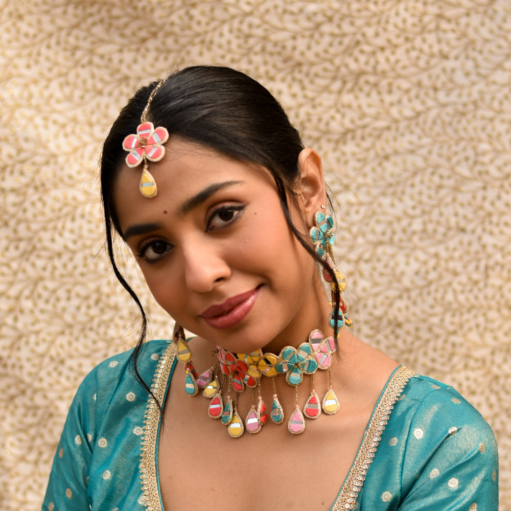 Indian bride wearing colorful imitation jewelry made of mirrors in floral pattern 