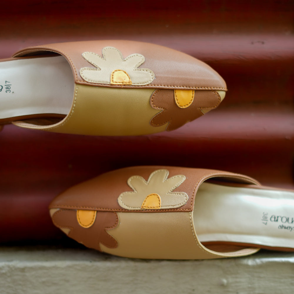 Modern brown mule featuring metallic gold panel and sleek profile
