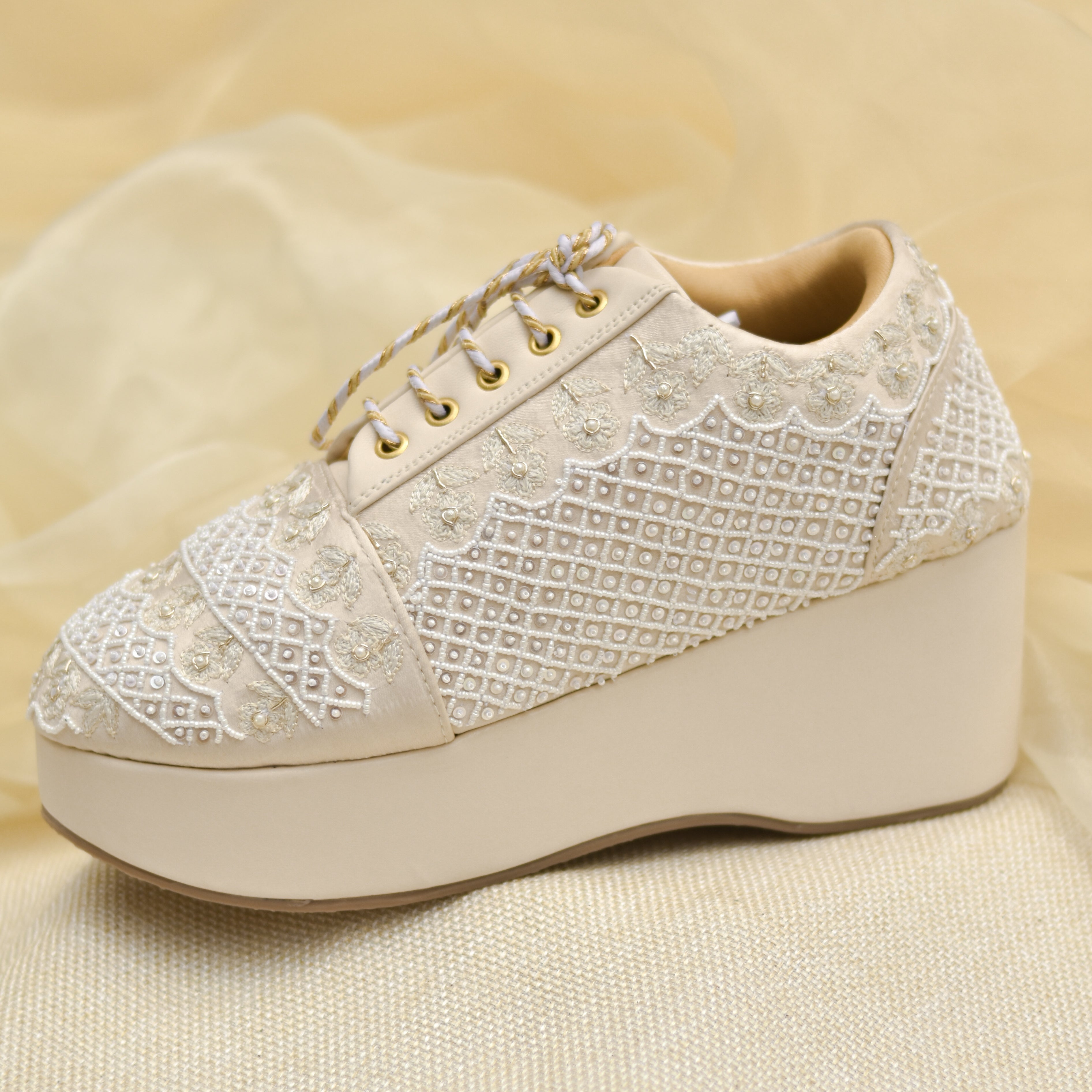 Comfortable ivory wedges with padded footbed and detailed surface embroidery