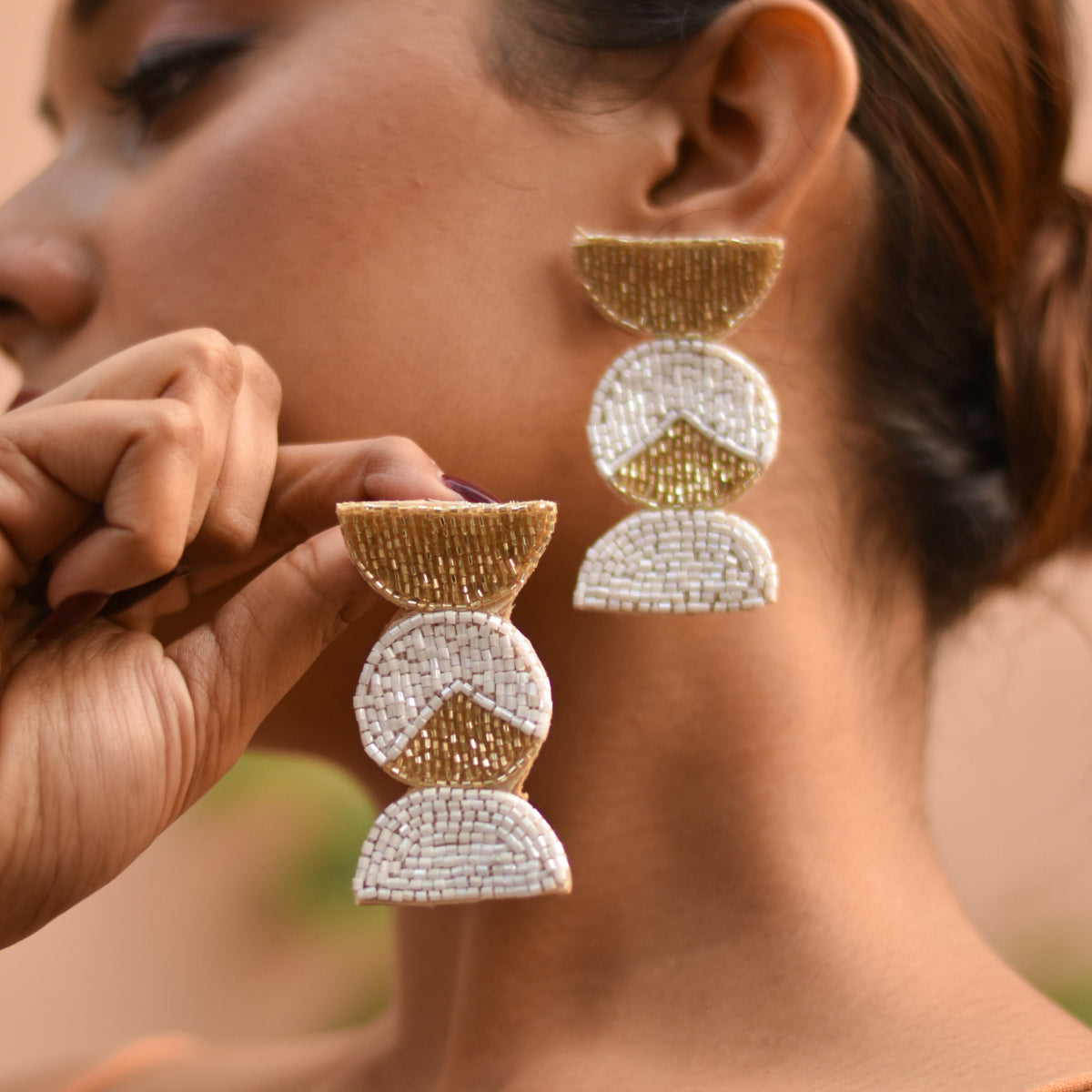 Candy shaped earrings in white and gold to add some drama to your haldi