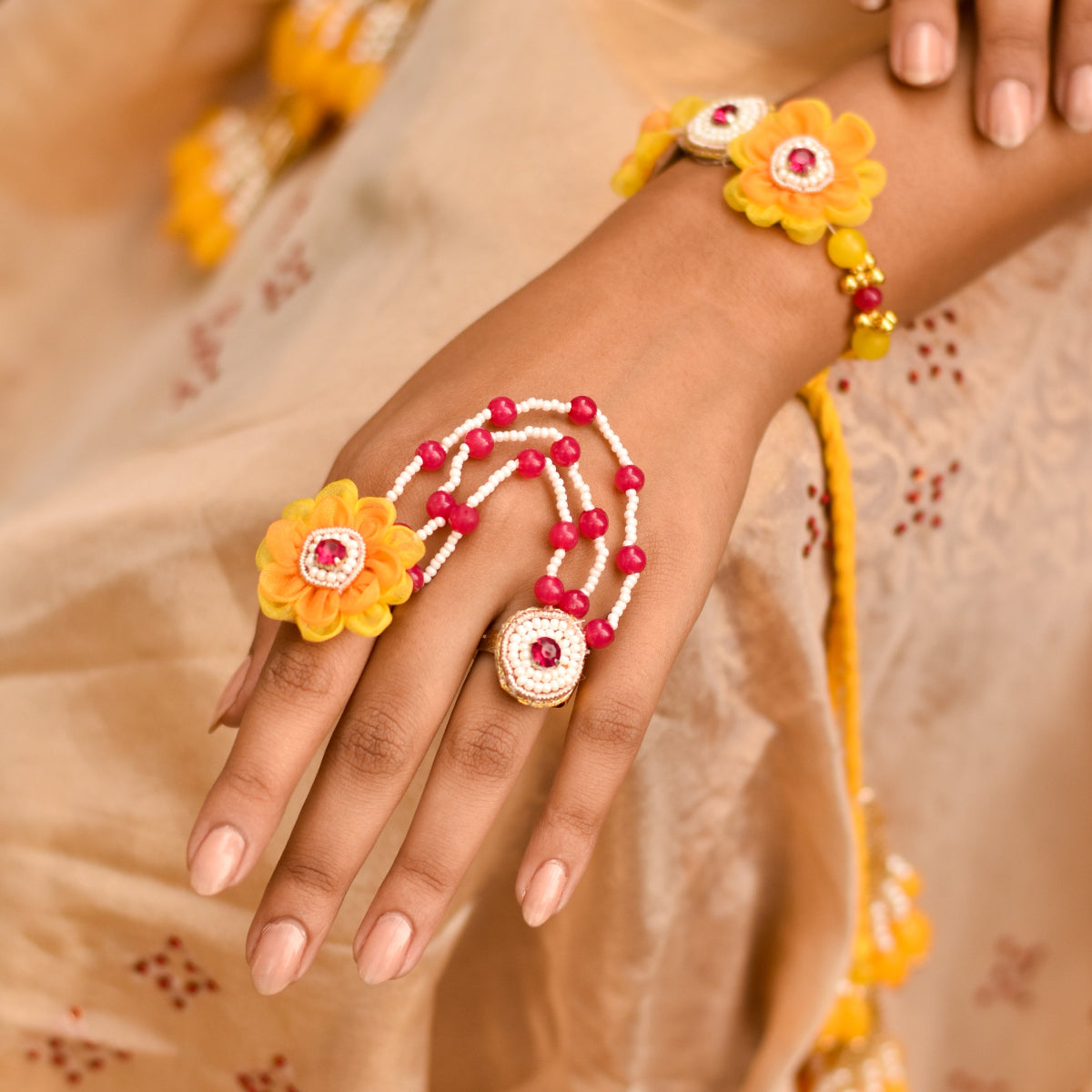 Yellow and pink floral and beaded rings from a imitation haldi set for bridesquad