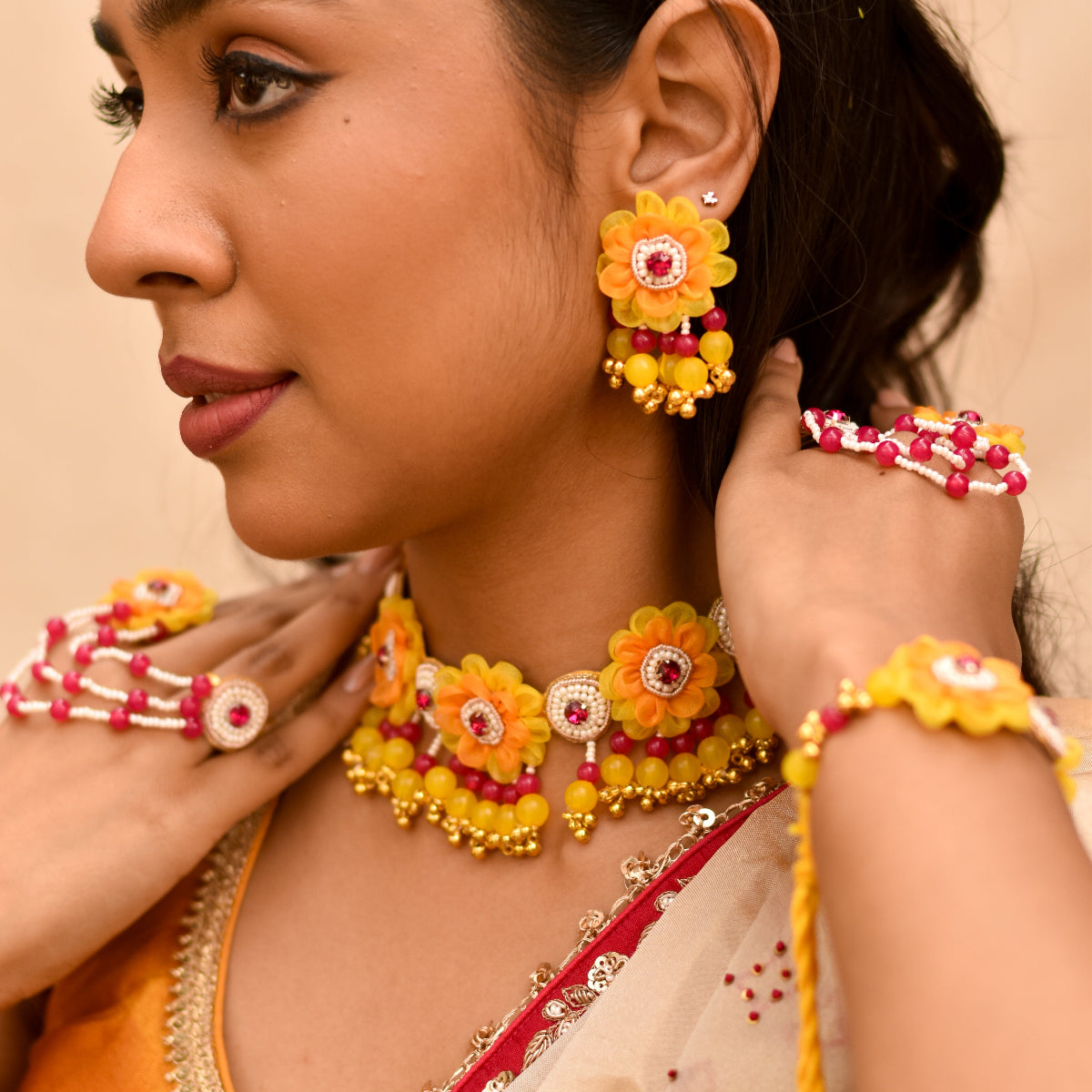 Yellow coloured earrings and necklace made of beads and dry flowers for ultimate haldi look 