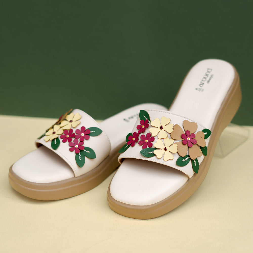 Ivory floral platform footwear with a broad decorative strap
