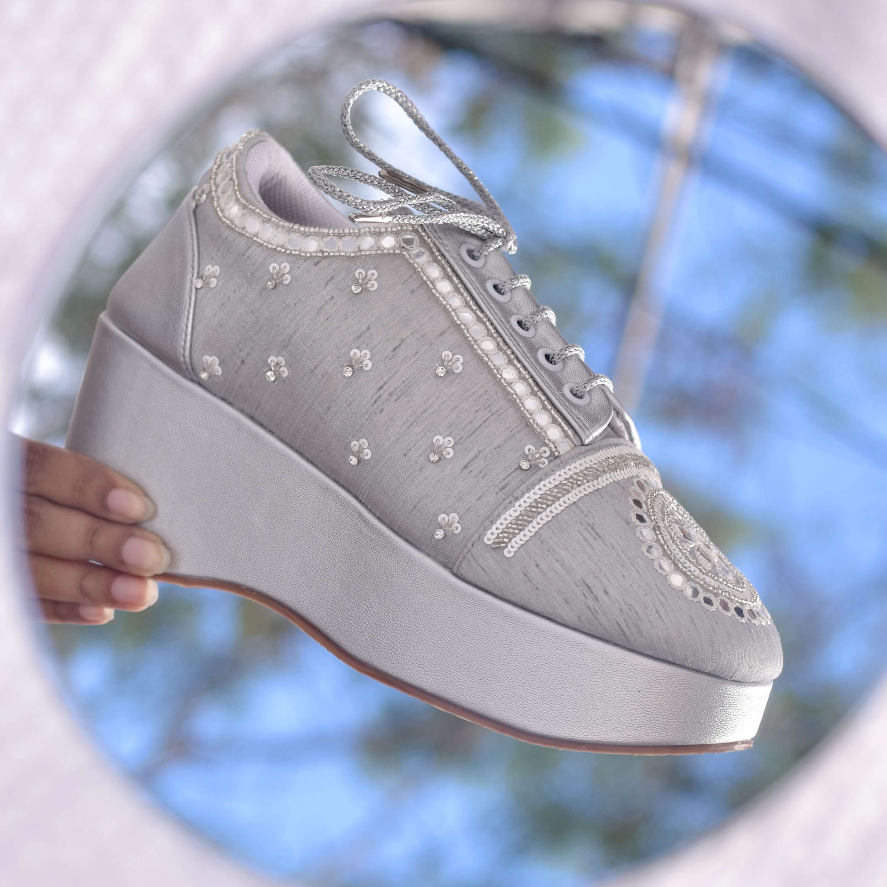 Designer silver wedding footwear featuring floral embroidery with pearls.