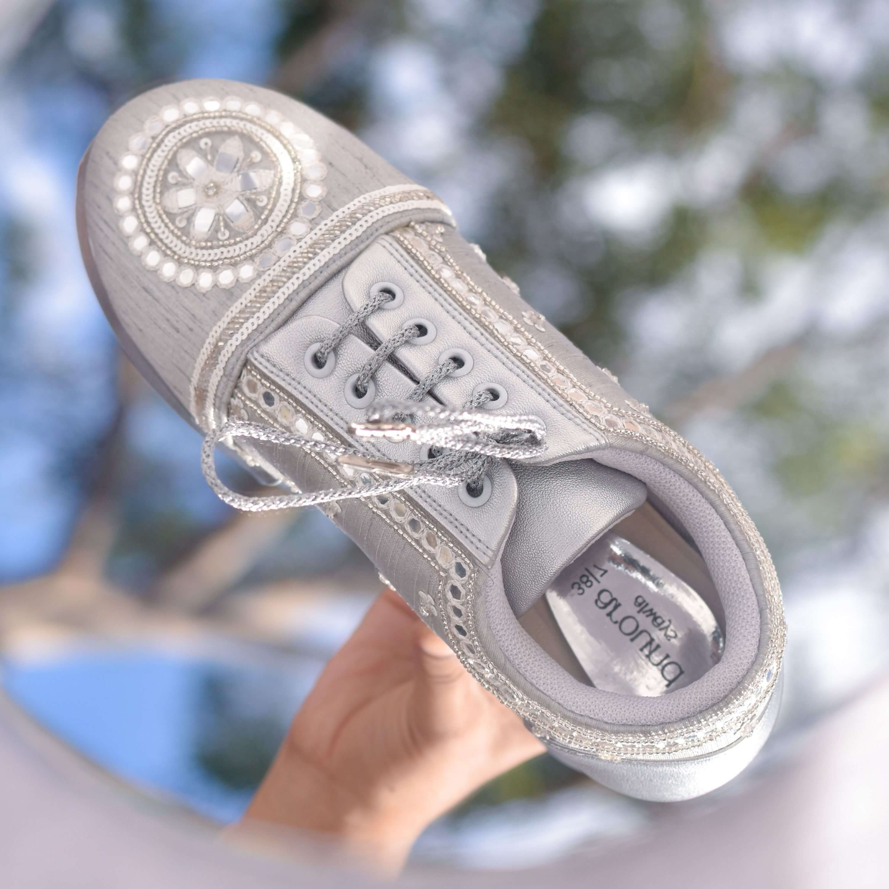 Silver wedge sneaker with pearl detailing and floral beadwork.