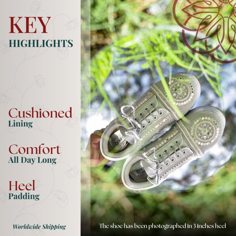 Silver embroidered sneaker with intricate circular motifs, cushioned interior, and padded heel for all day comfort