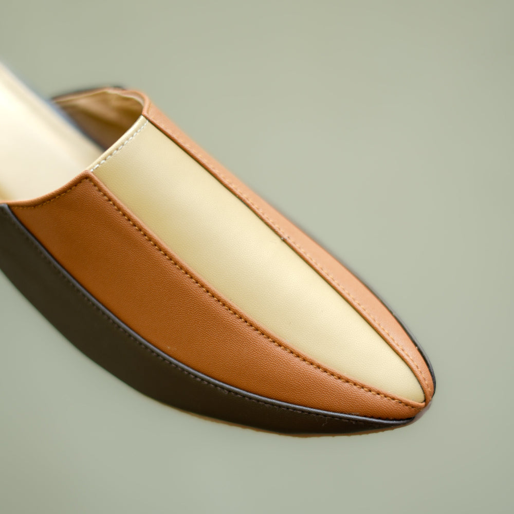 Neutral-toned flat mule featuring playful flower design and low heel
