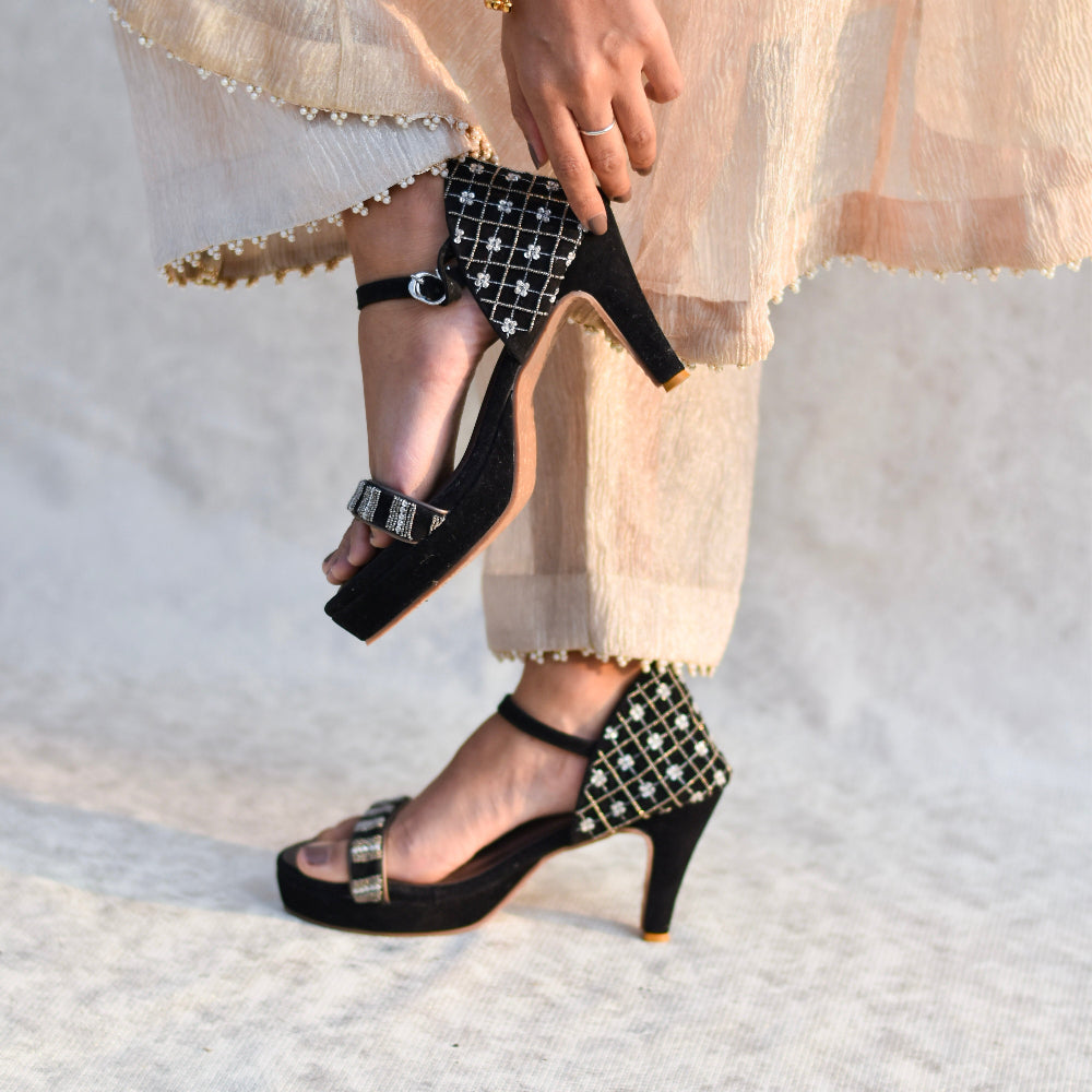 Black party heels with detailed front strap, stable heel and cushioned footbed.