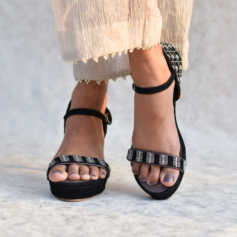 Black sandals with embroidered strapsand antiskid sole.