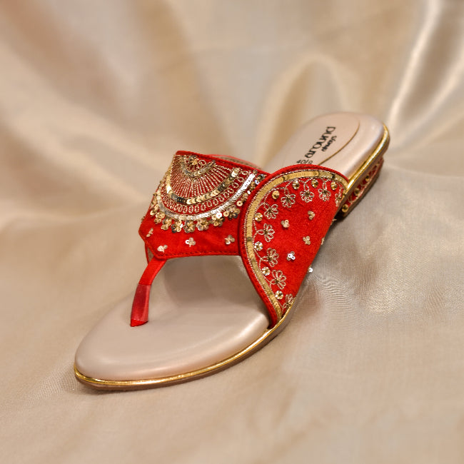 Close-up of festive red open-toe heels with zari detailing on front strap