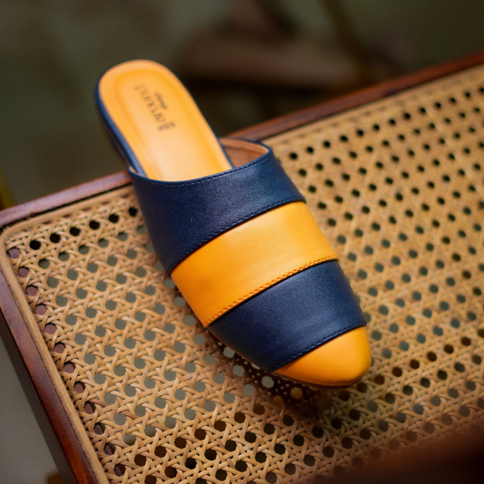 Pointed-toe mule in navy and mustard tones with cushioned footbed