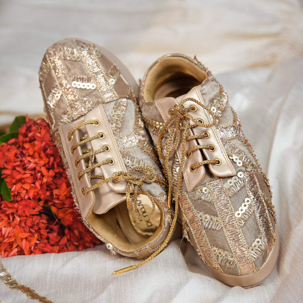 Metallic champagne sneaker featuring geometric gold textile panels
