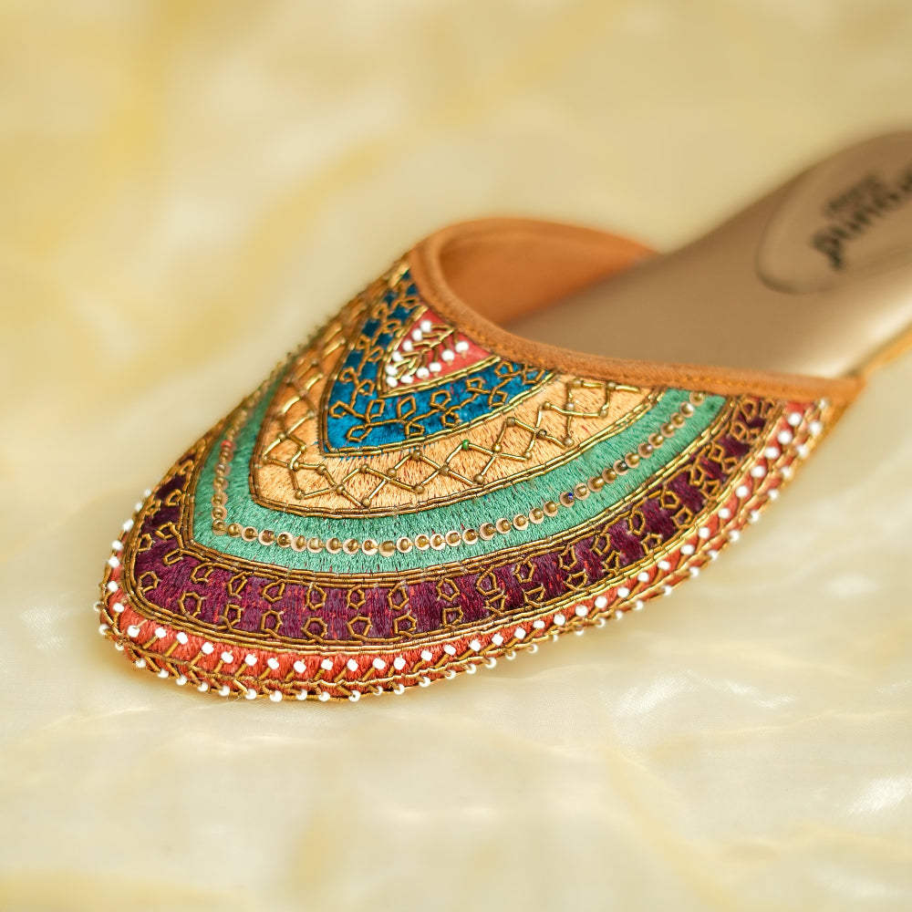 Hand-embroidered festive mule featuring vibrant layered motifs and pointed toe