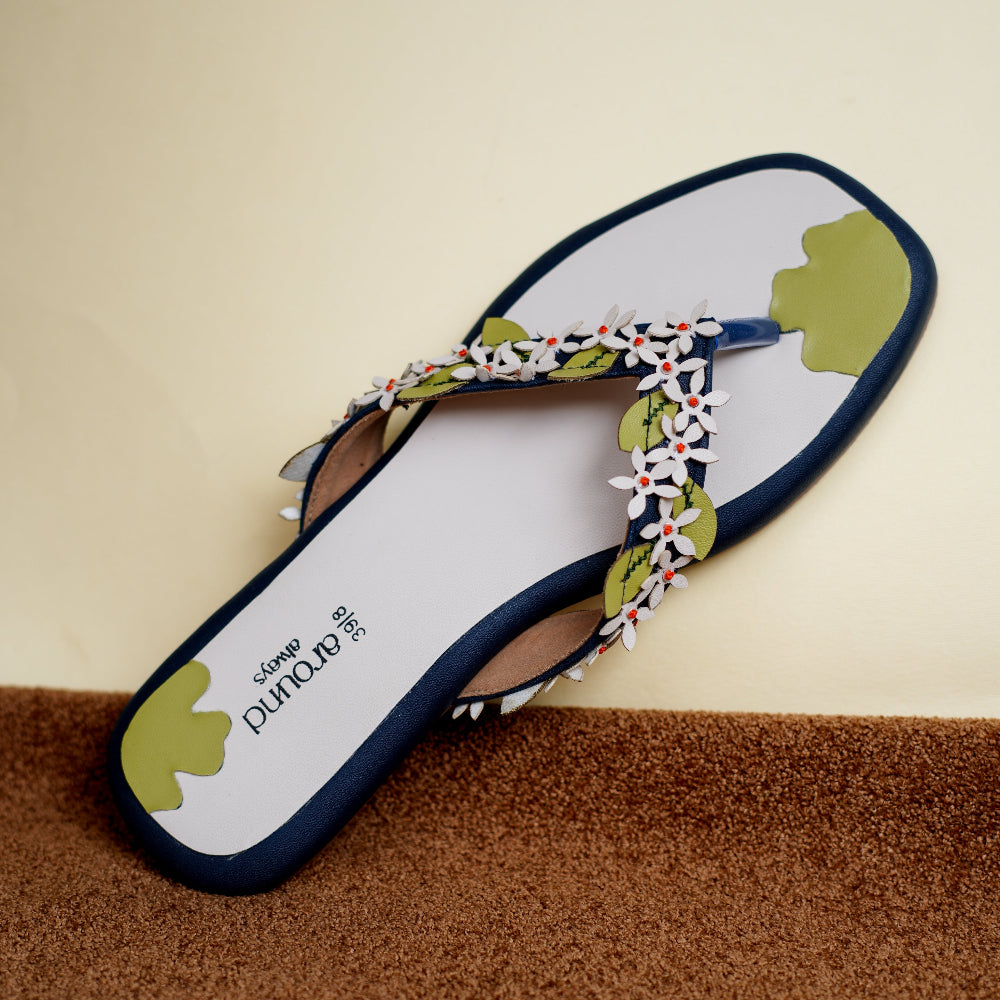 Strappy navy footwear decorated with a trail of tiny floral motifs
